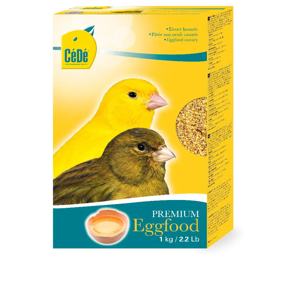Une boîte jaune de 1 kg de pâtée aux œufs canari Cédé présente des images de canari jaune et vert. Riche en protéines animales, ce produit est idéal pour nourrir vos amis à plumes.